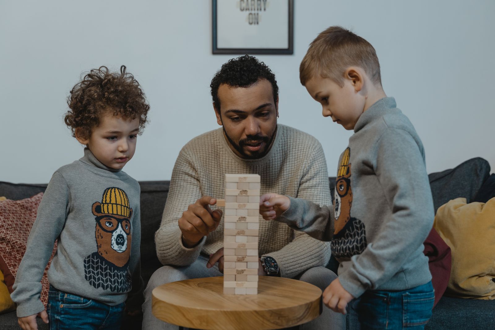 Vater begleitet zwei Kinder bei einem gemeinsamen Geschicklichkeitsspiel